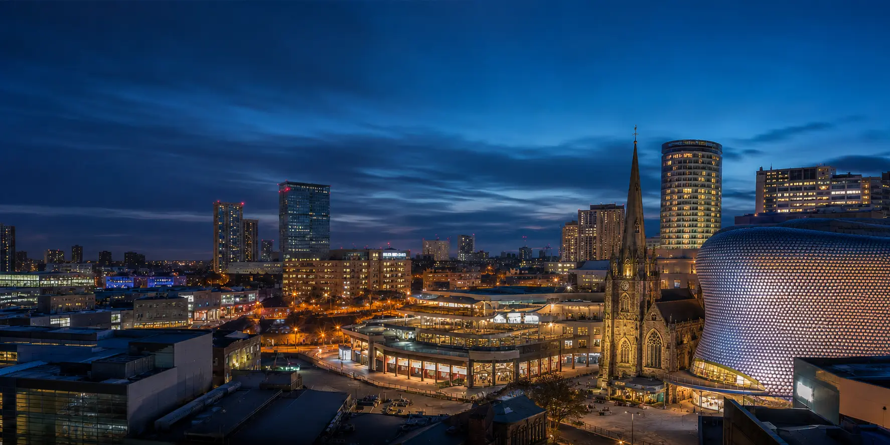 Birmingham skyline at blue hour with St Martin’s Church beside the Bullring