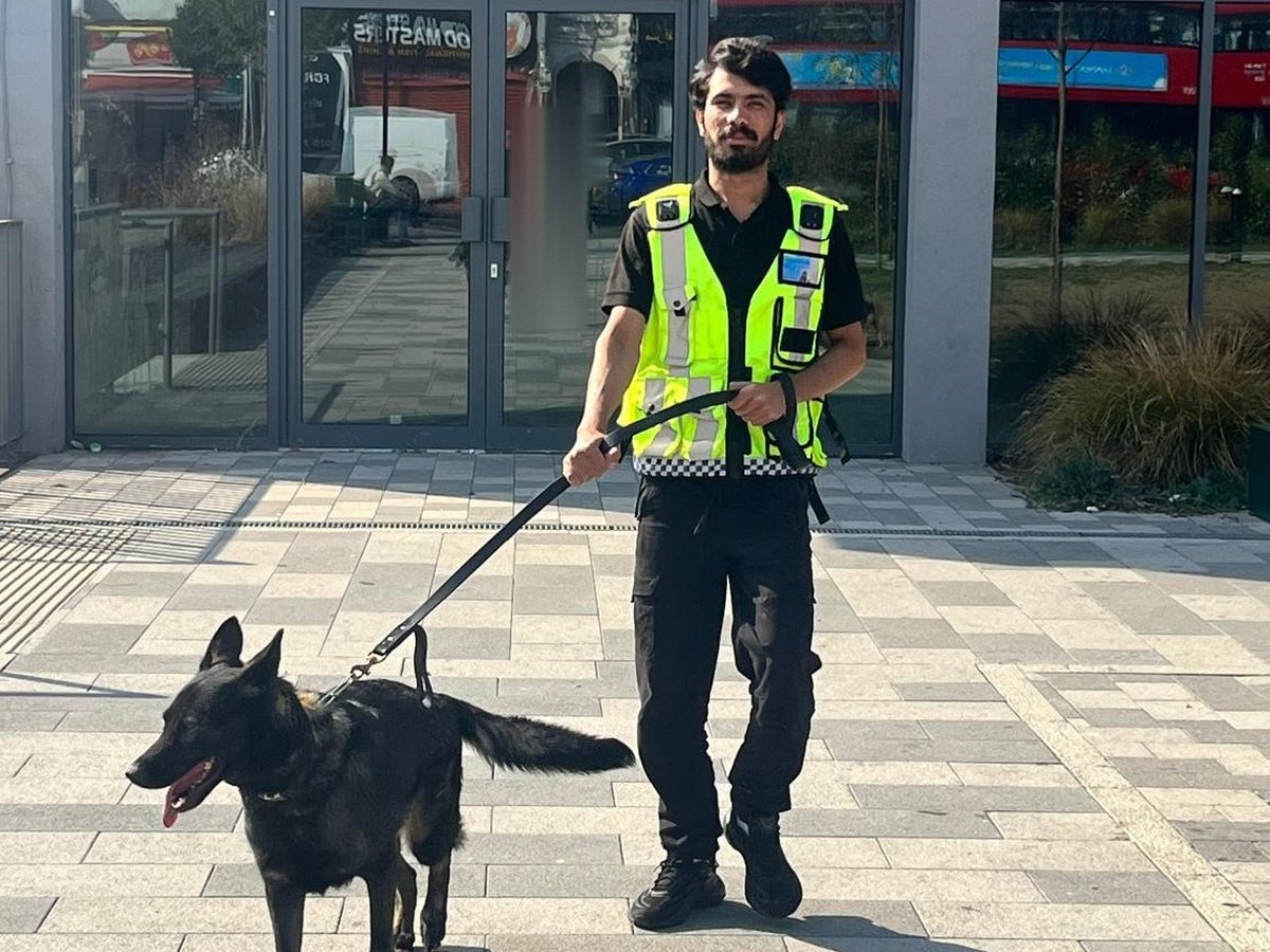 SIA licensed K9 handler walking a patrol dog at a vacant building